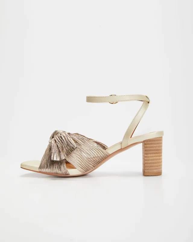 Cara Metallic Gold Bow Heels sold by Vici