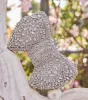 Looks So Divine Rhinestone Bow Minaudiere Clutch sold by Windsor