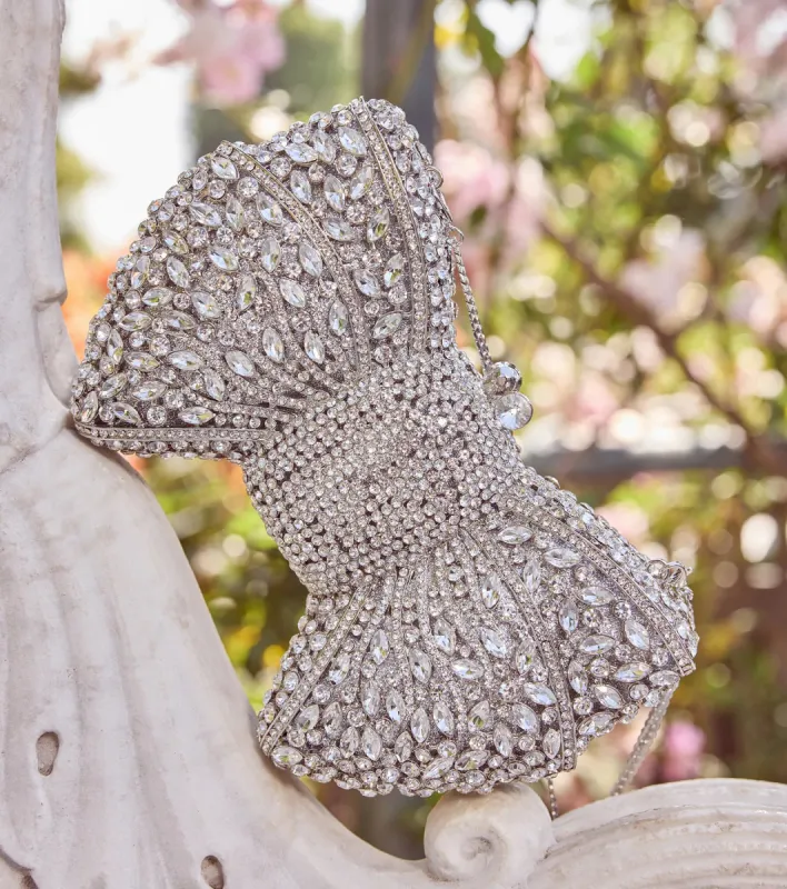 Looks So Divine Rhinestone Bow Minaudiere Clutch sold by Windsor