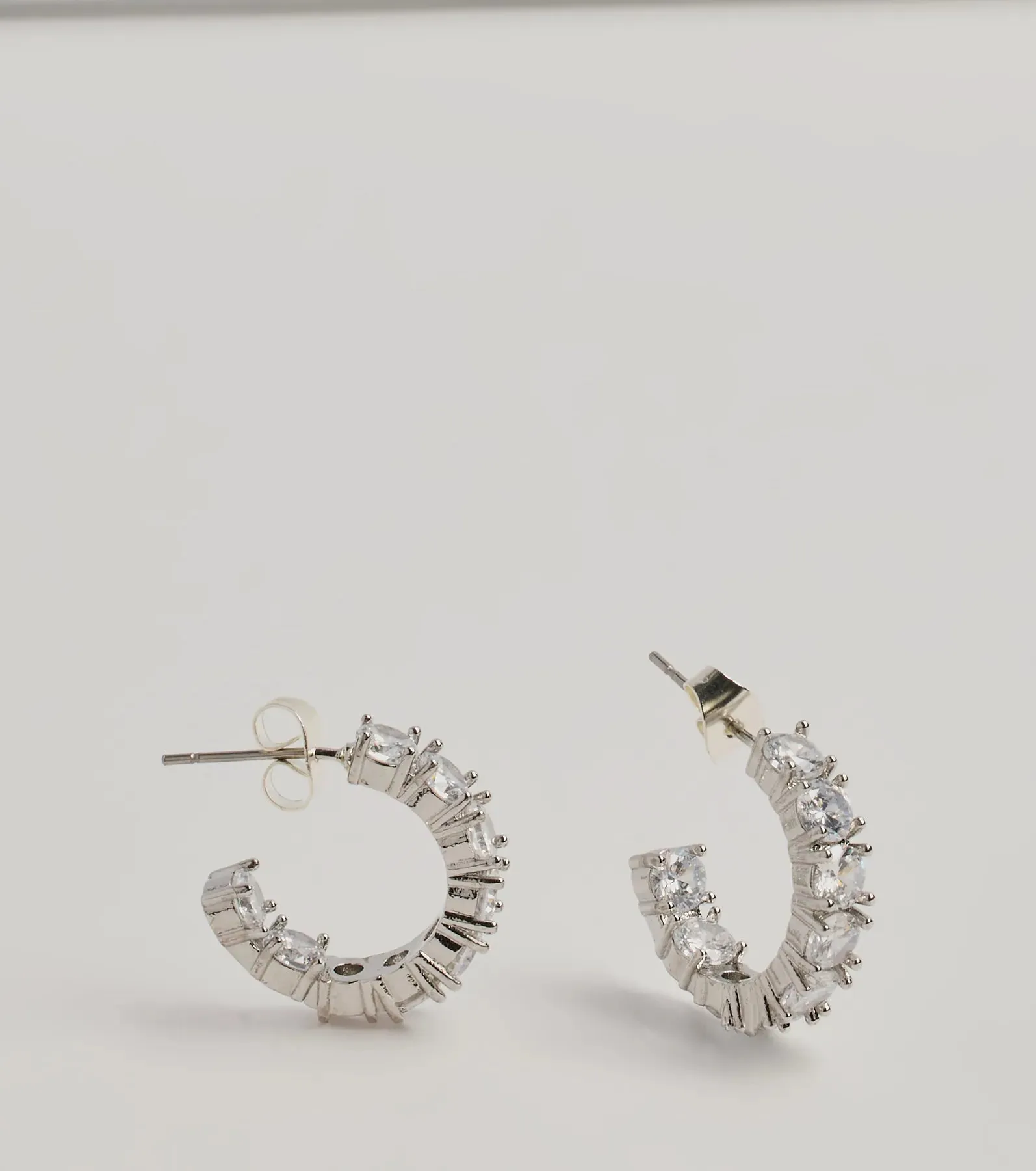 Stylish Staple Cubic Zirconia Mini Hoop Earrings sold by Windsor