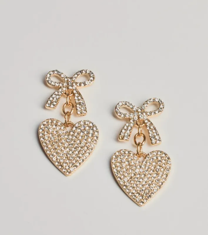 Whimsy Charm Rhinestone Bow And Heart Earrings sold by Windsor