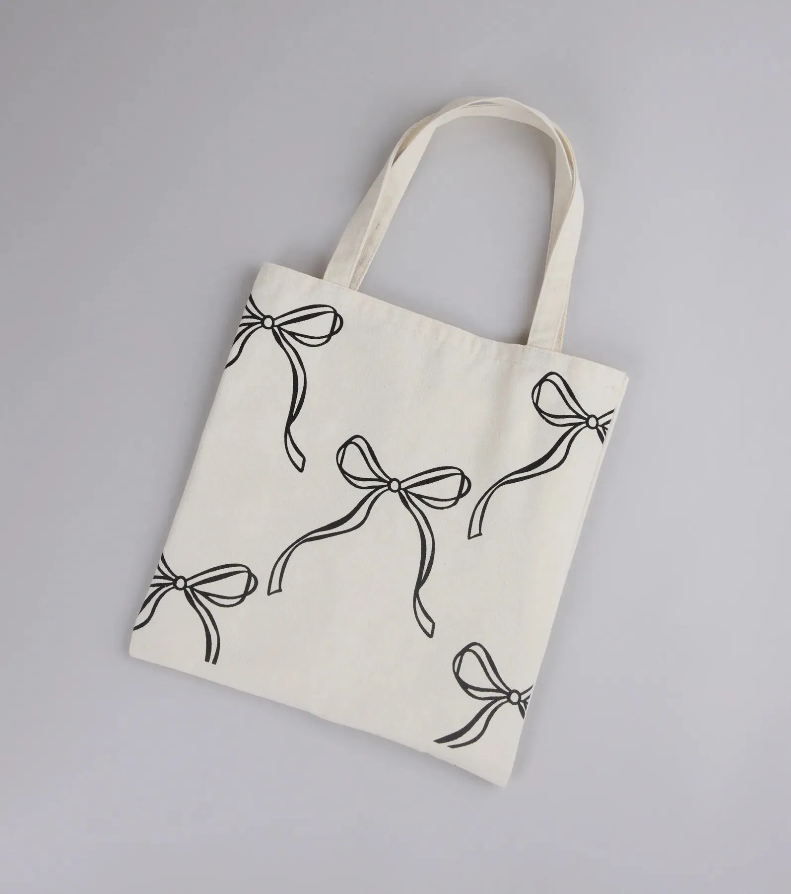 Take A Bow Print Canvas Tote Bag sold by Windsor