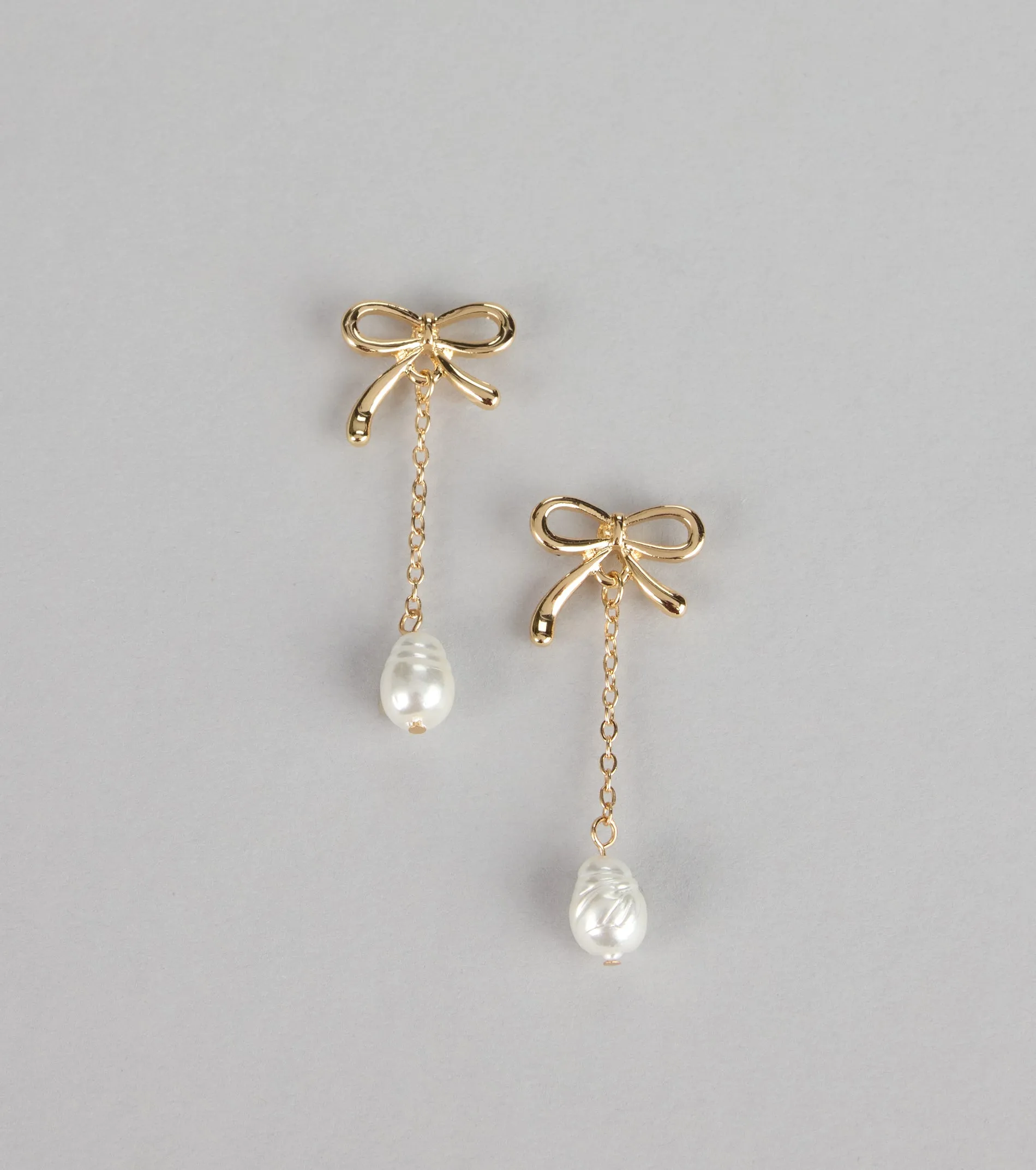 Charm Me Bow Dangle Pearl Earrings sold by Windsor