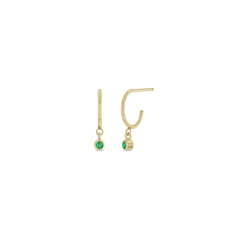 14k Dangling Emerald Huggie Hoops | May Birthstone sold by Zoe Chicco