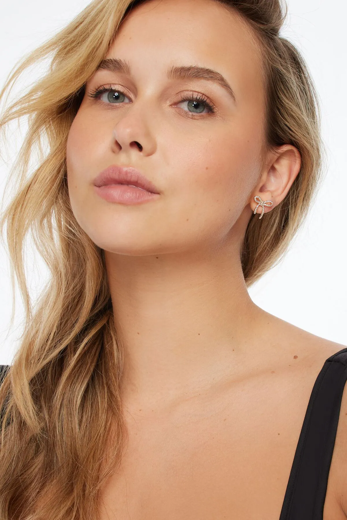 Mini Gem Bow Earrings sold by Dynamite