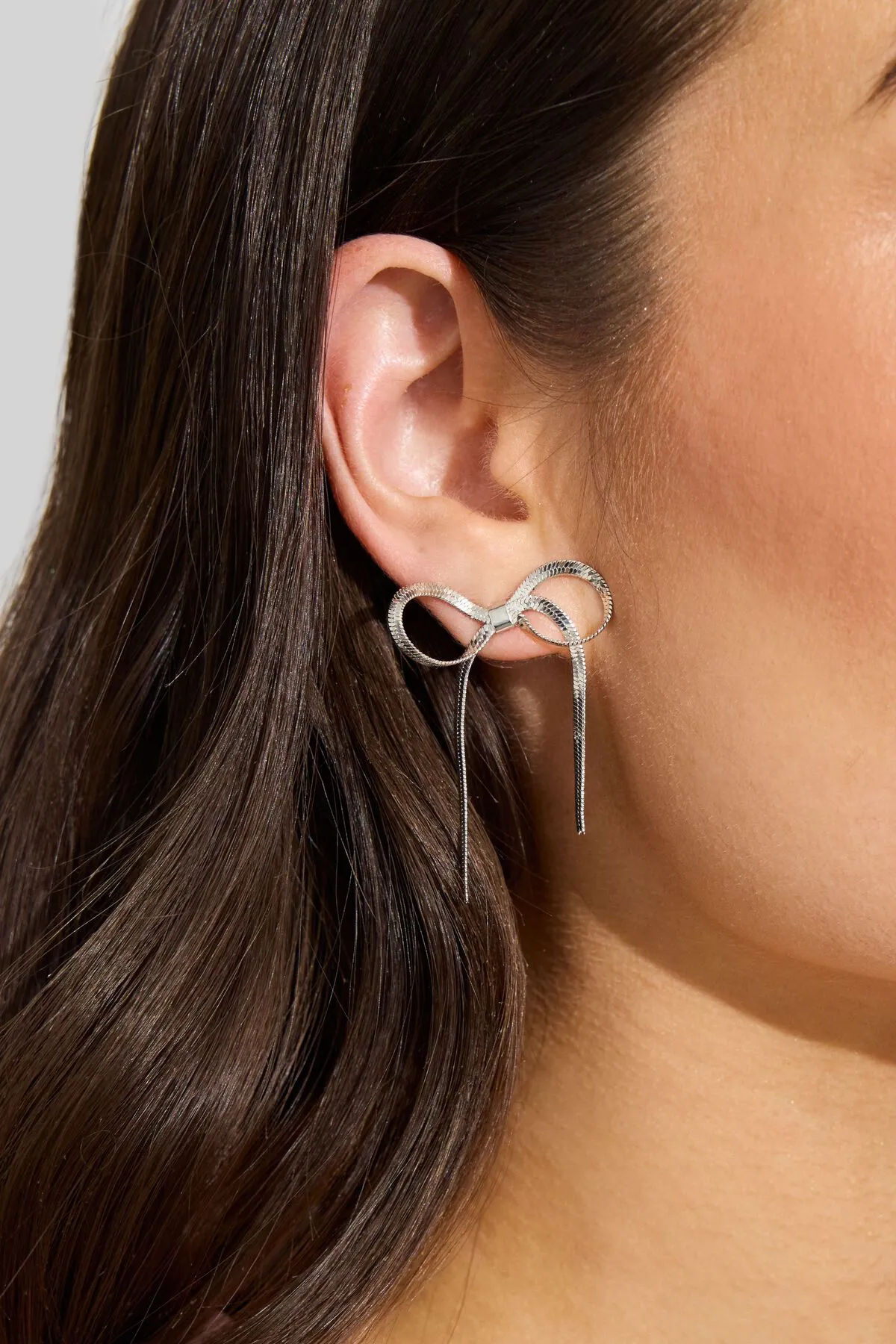 Snake Chain Bow Earrings sold by Garage