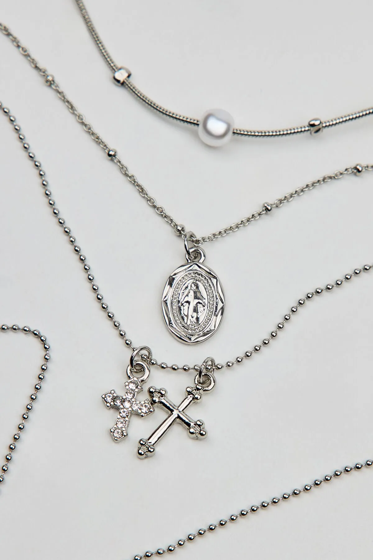 Set of 3 Pearl, Cross, and Pendant Necklaces sold by Garage