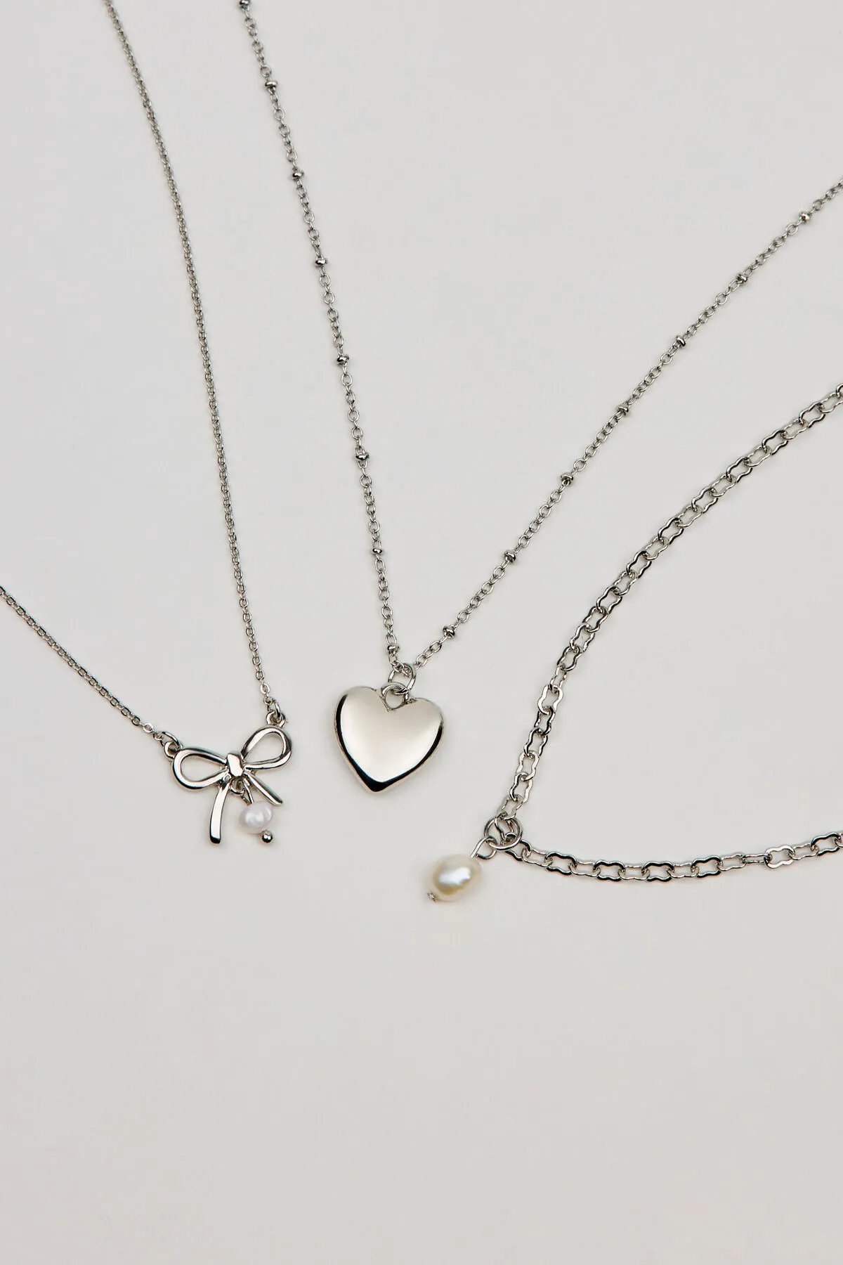 Set of 3 Bow, Pearl, and Heart Necklaces sold by Garage