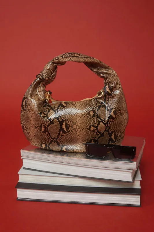 Laisha Brown Snake Print Knotted Shoulder Bag sold by Lulus