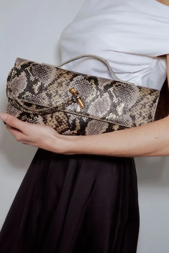 Magella Brown Snake Print Clutch sold by Lulus