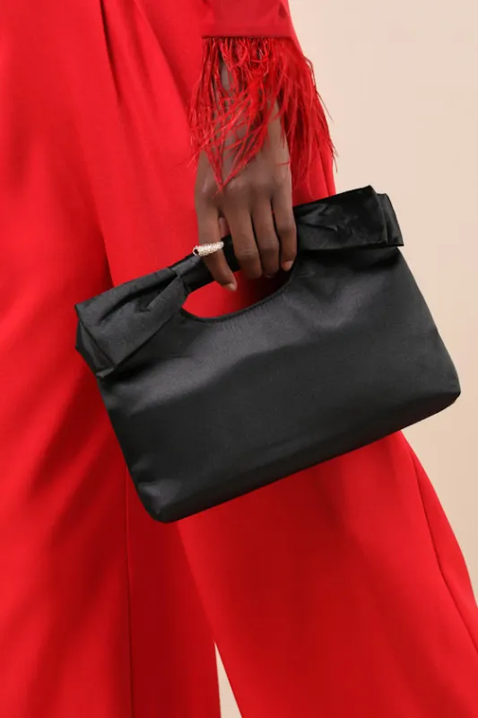 Total Romantic Black Satin Bow Clutch sold by Lulus