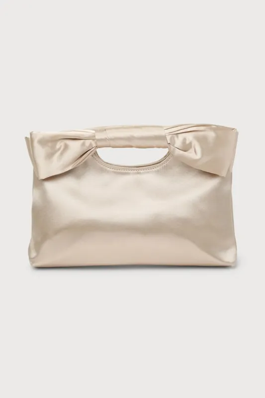 Total Romantic Champagne Satin Bow Clutch sold by Lulus