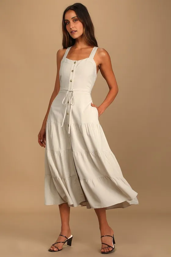 See the City Beige Button-Front Tiered Midi Dress sold by Lulus