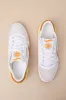 Classic Leather White and Amber Suede Sneakers sold by Lulus