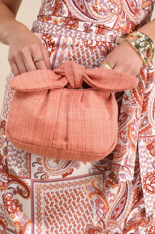 Essential Style Rusty Rose Woven Knot Handle Clutch Bag sold by Lulus