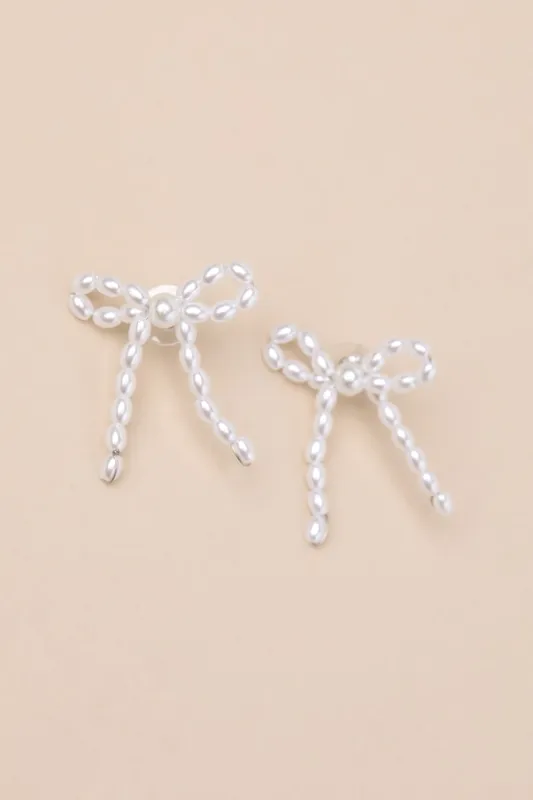 Glowing Vibe White Pearl Bow Earrings sold by Lulus