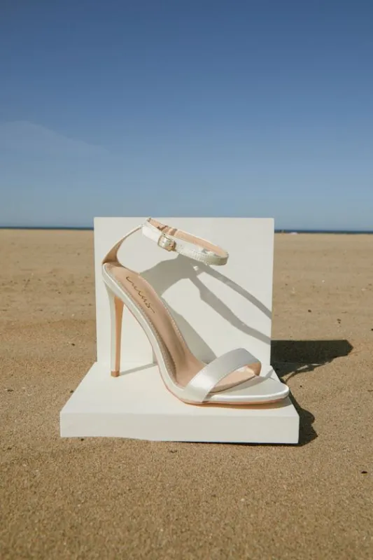 Ellyy White Satin Ankle Strap Stiletto Heels sold by Lulus
