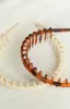 The Holly Cream Headband sold by Beginning Boutique
