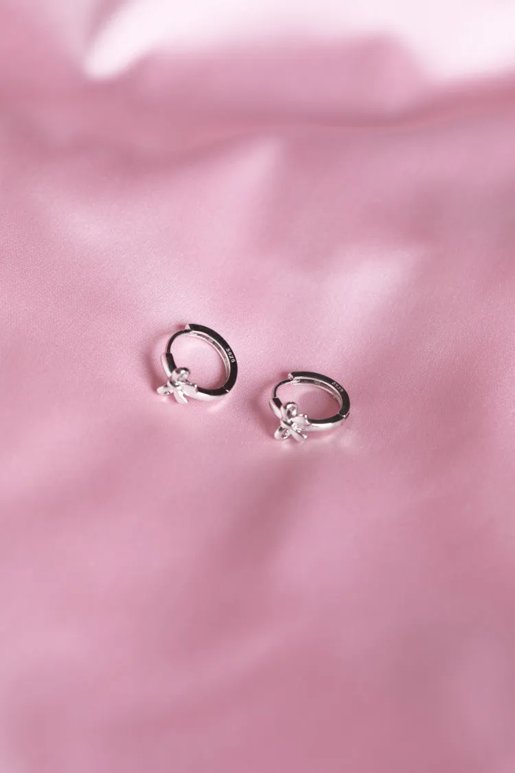 Darling Silver Bow Huggie Earrings sold by Beginning Boutique product image thumbnail 4