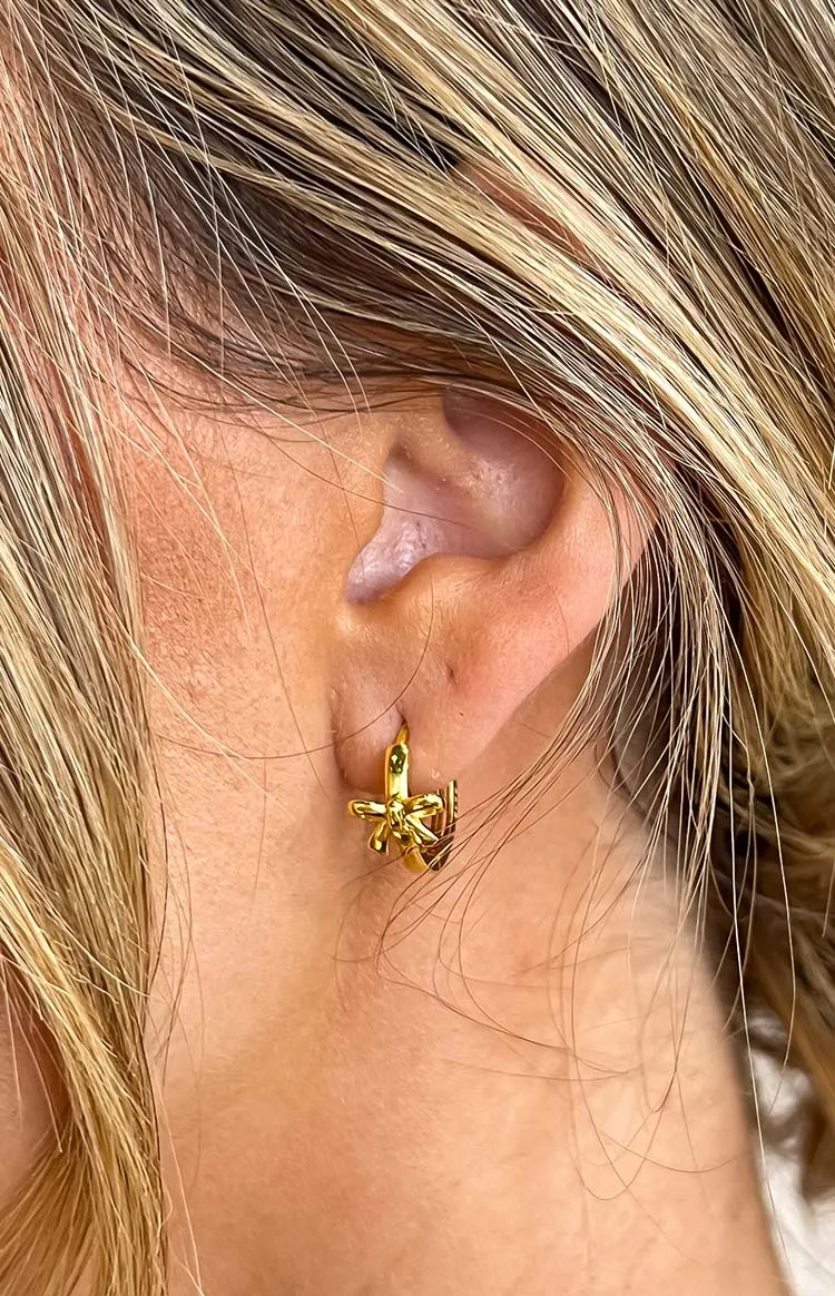 Darling Gold Bow Huggie Earrings sold by Beginning Boutique