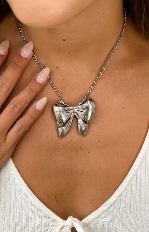 Merrelle Silver Bow Pendant Necklace sold by Beginning Boutique