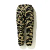 BAPE 1ST CAMO STRETCH TRACK PANTS sold by PLUS