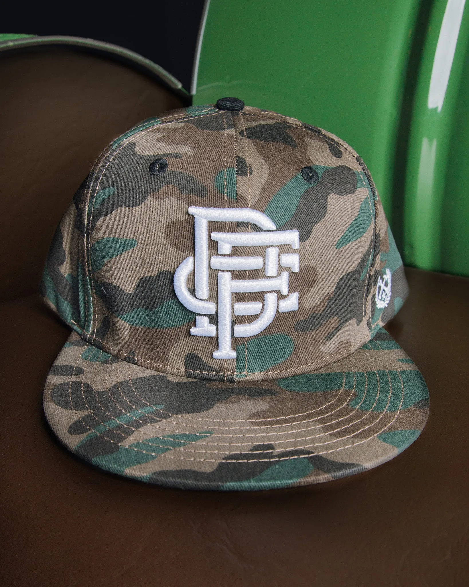 Badge Flat Bill Snapback - Camo sold by Dixxon