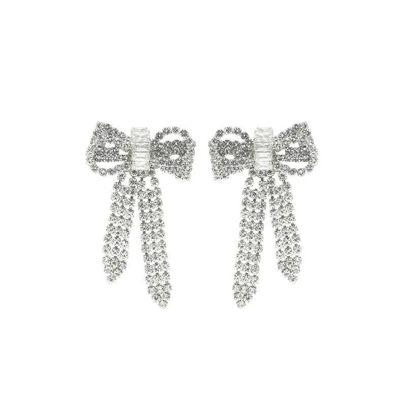 SILVER BOW EARRINGS CLEAR STONES ( 27195 CRS ) sold by Oh My Jewelry