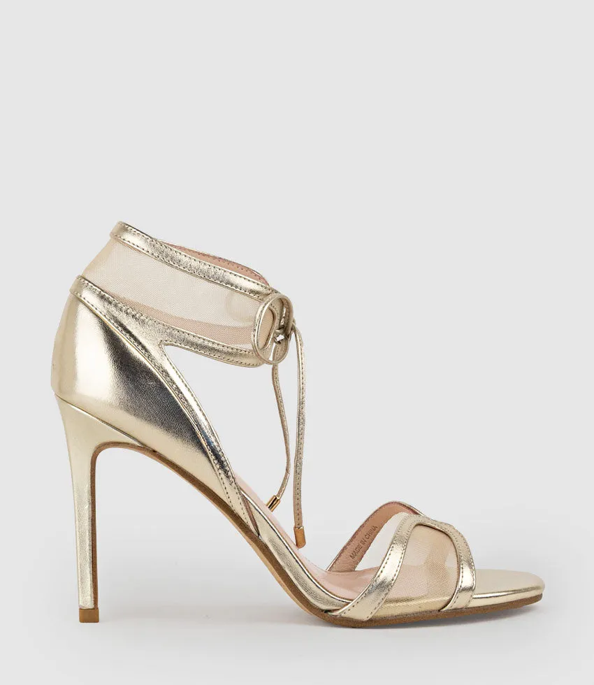 WINSLEY100 Asymmetrical Strappy Sandal in Gold sold by Edward Meller