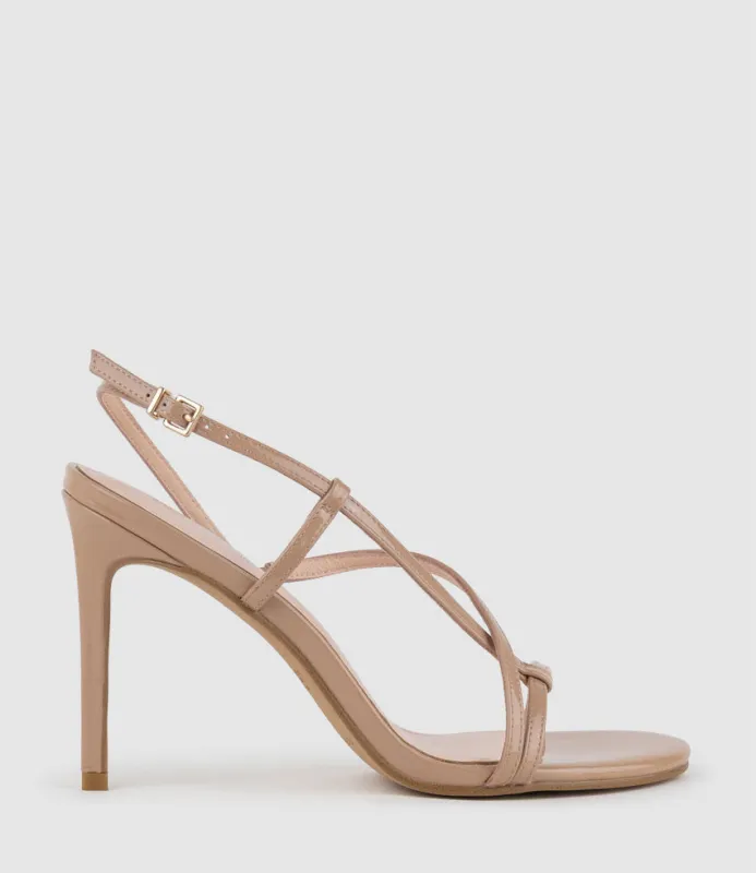 WRAITH100 Asymmetrical Strappy Sandal in Nude Patent sold by Edward Meller