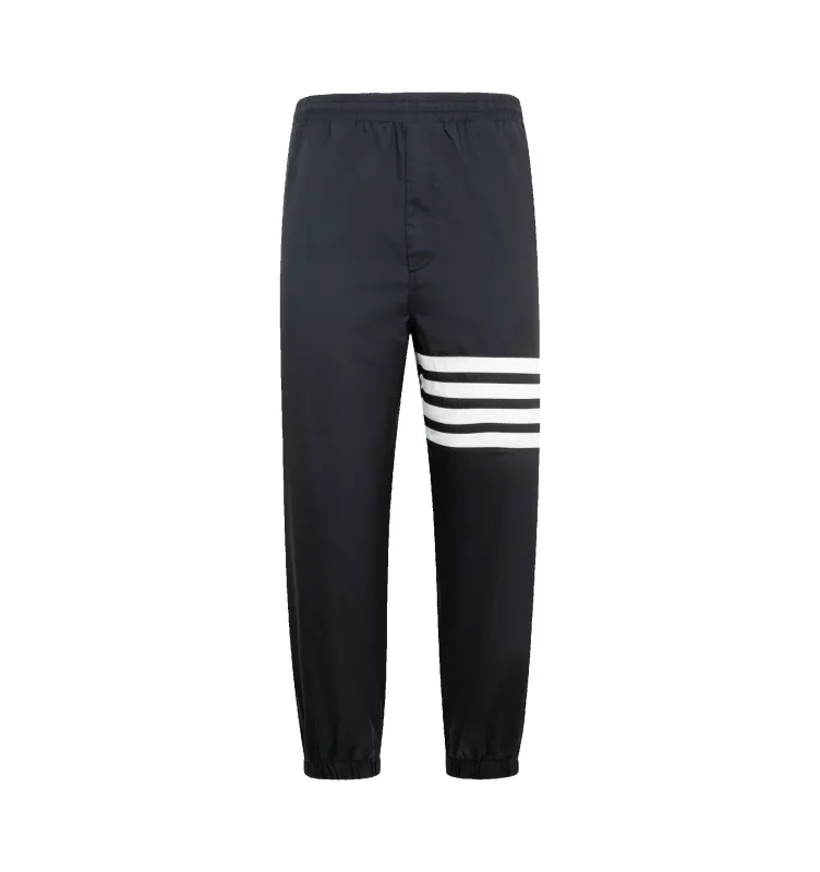 SHINY RIPSTOP TRACK PANTS (MENS) made by Thom Browne