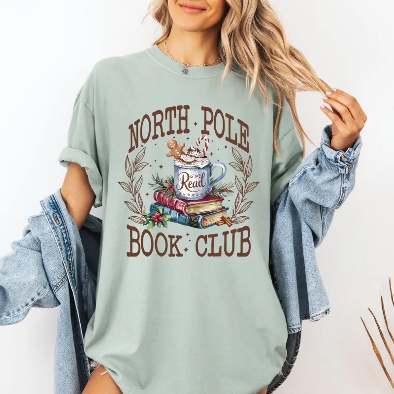 North Pole Book Club, Reading, Teacher, Cozy, Christmas, Santa, Library Tshirt Comfort Colors T-Shirt sold by Refinery Number One