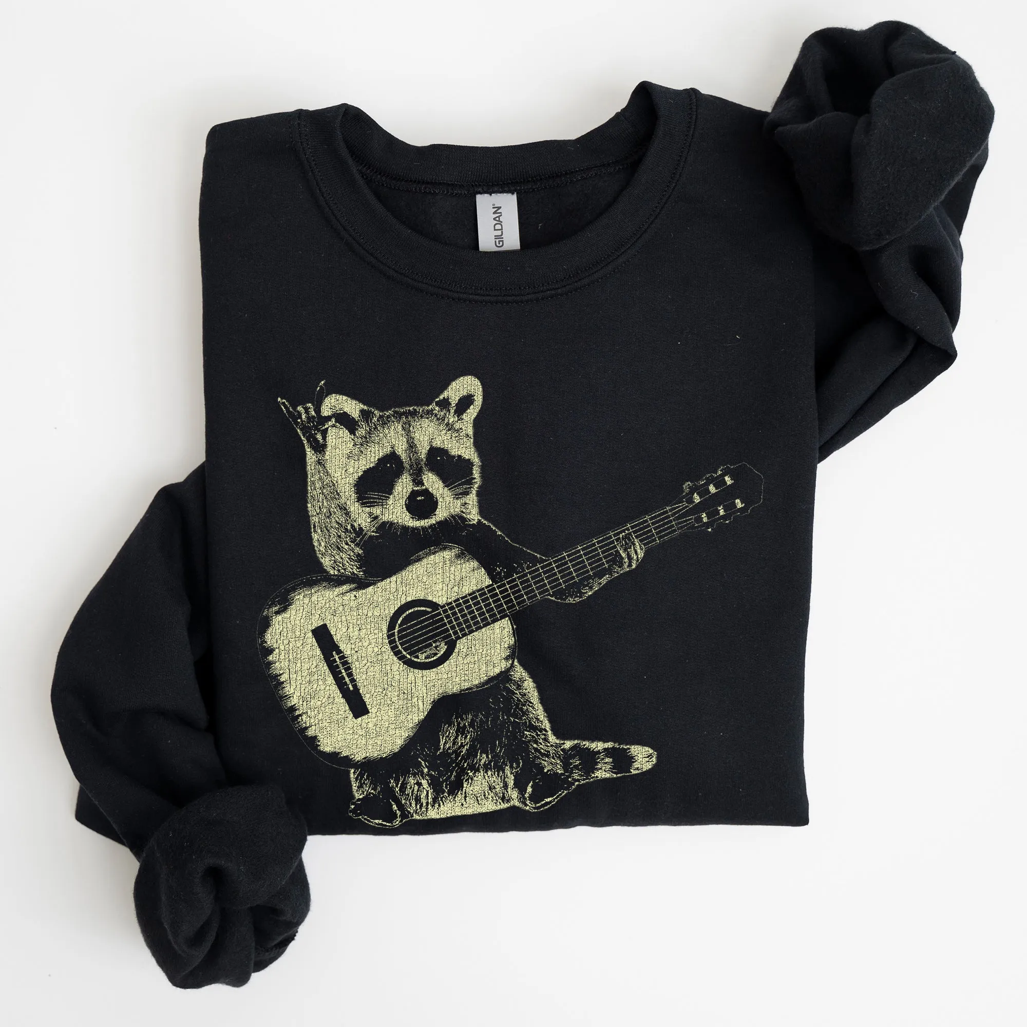 Raccoon Playing A Guitar In A Whimsical Forest Scene With Playful Vibe Sweatshirt sold by Refinery Number One