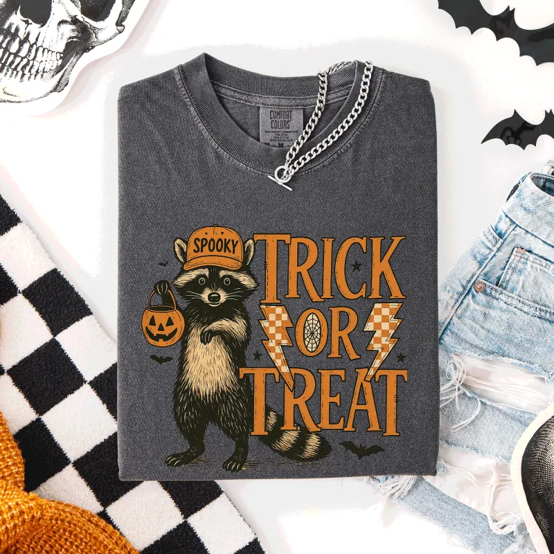 Trick or Treat Raccoon Halloween Mischief With Skeletons Ghosts Cats And Pumpkins Comfort Colors Tee made by Refinery Number One