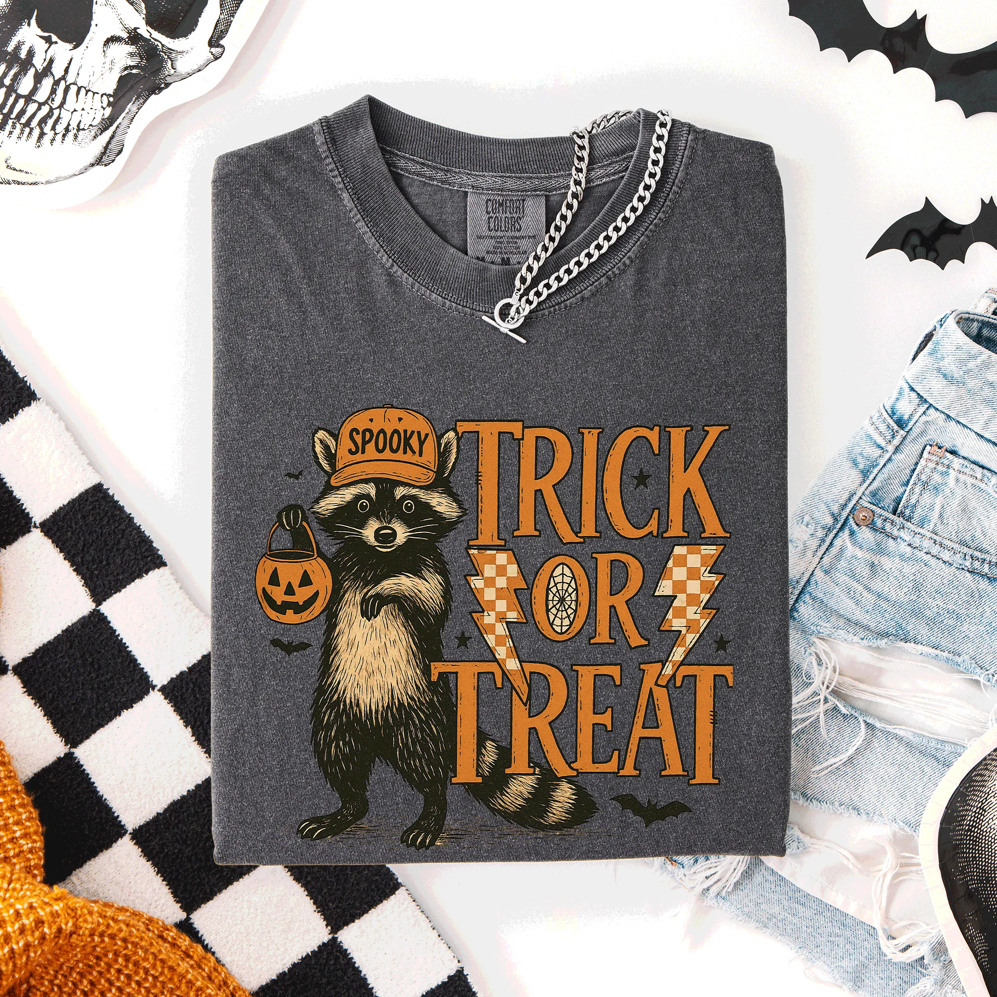 Trick or Treat Raccoon Halloween Mischief With Skeletons Ghosts Cats And Pumpkins Comfort Colors Tee sold by Refinery Number One