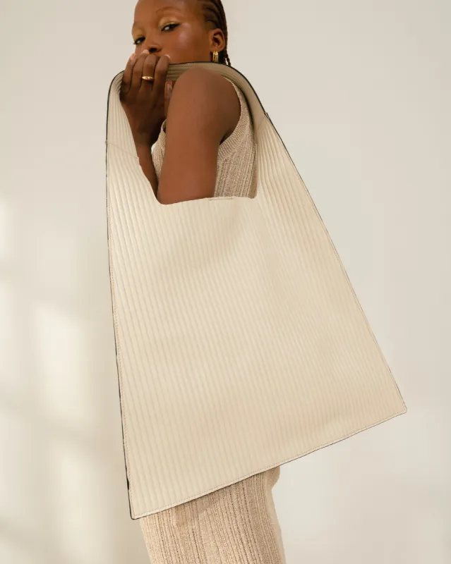 The L Pleated Cream Leather Tote Bag sold by Alohas