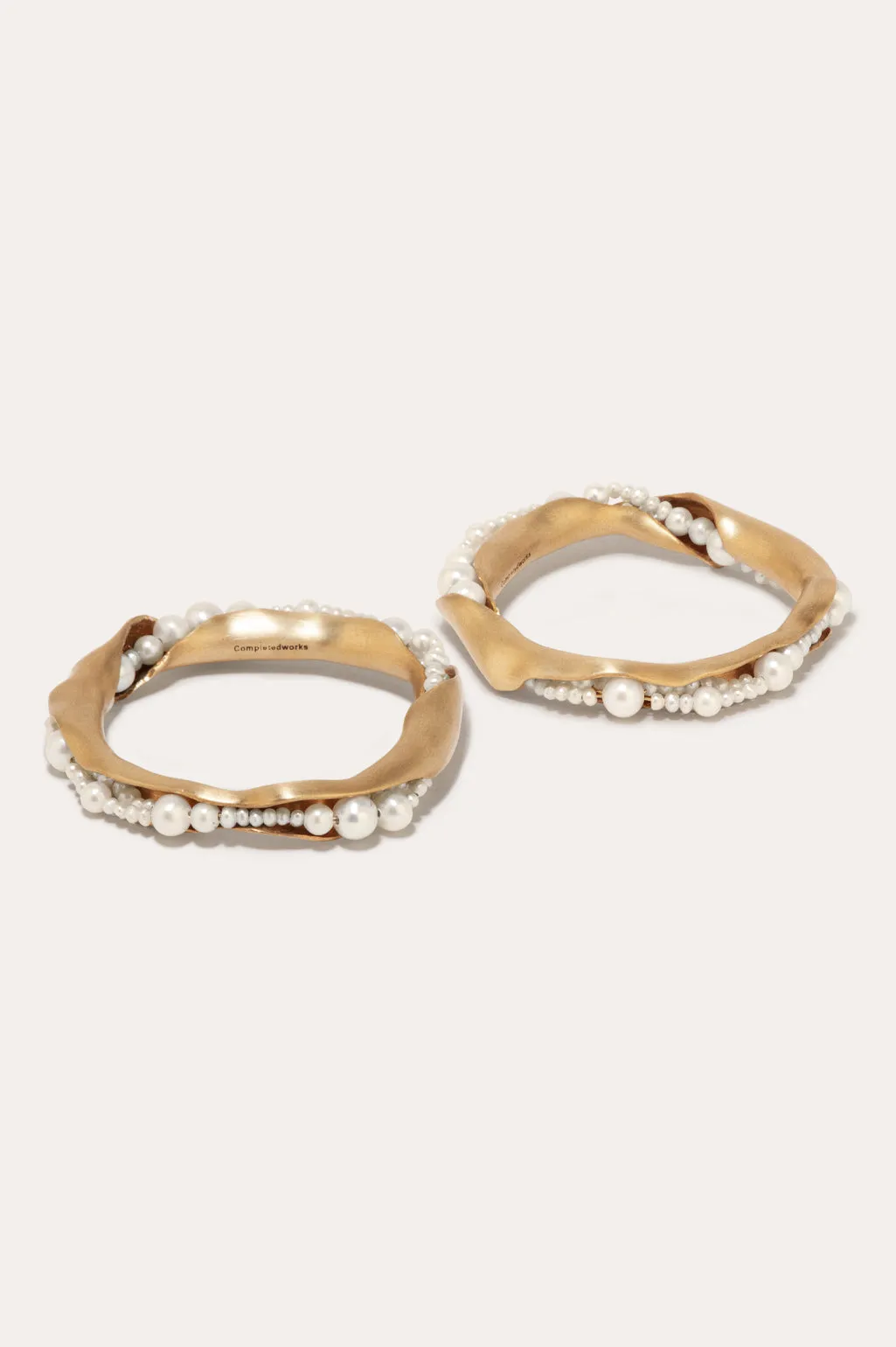 L01 - Set of 2 Napkin Rings in Brushed Brass w/ Faux Pearls sold by Completed Works