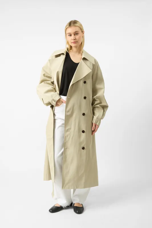 The Frankie Shop Mavis Oversize Long Trench Coat in Beige sold by Bessette