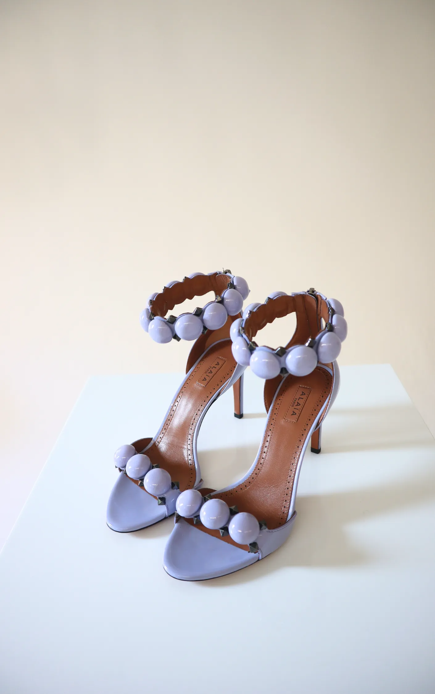 Alaïa La Bombe 90 Patent Heels sold by Bessette