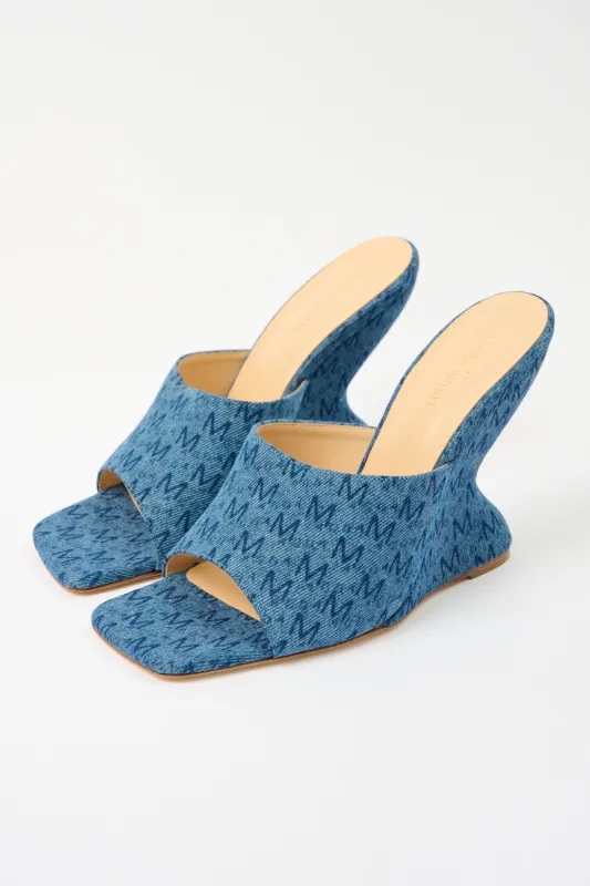 Denim Mules sold by Bessette