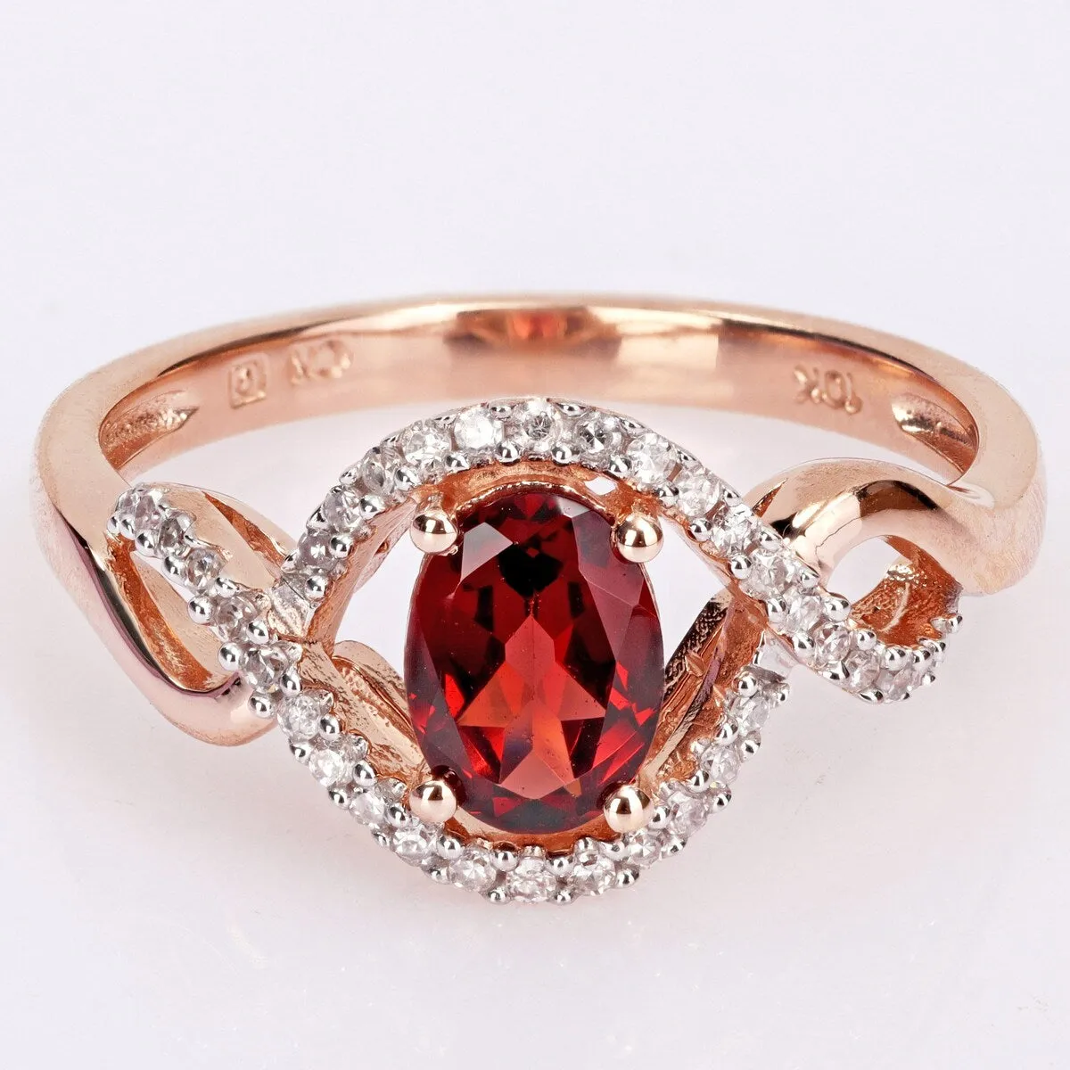 Miadora 10k Rose Gold Garnet and 1/6ct TDW Diamond Halo Infinity Ring sold by Zulily