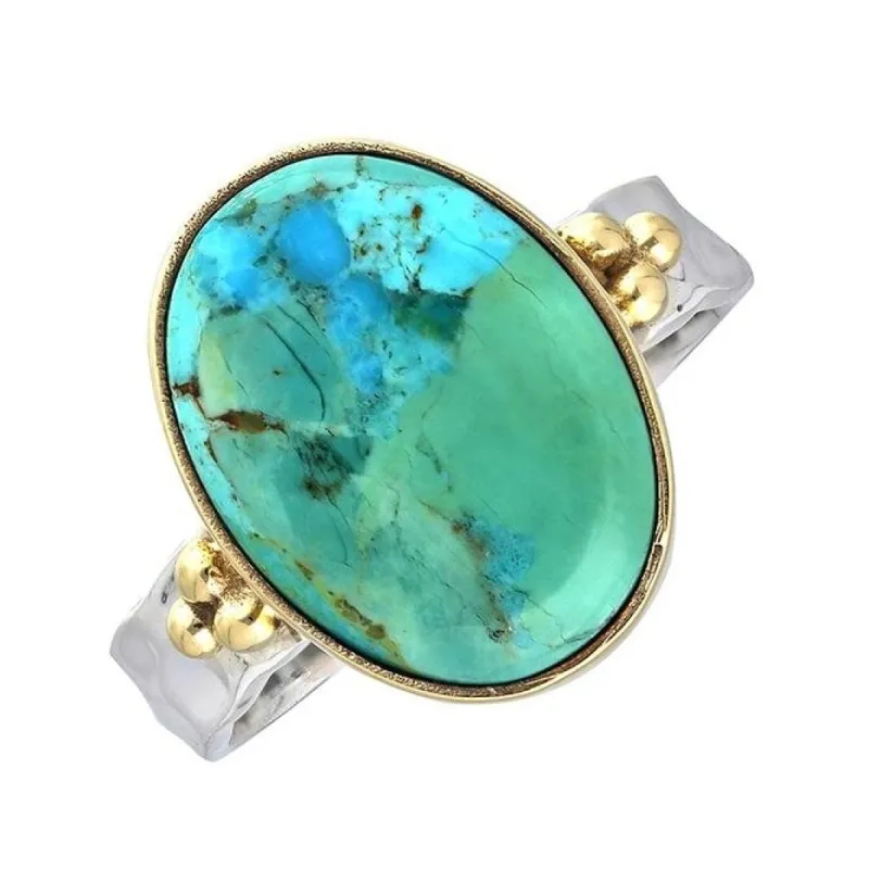 Sterling Silver Oval Shaped Blue Mohave Turquoise with Brass Accents sold by Zulily