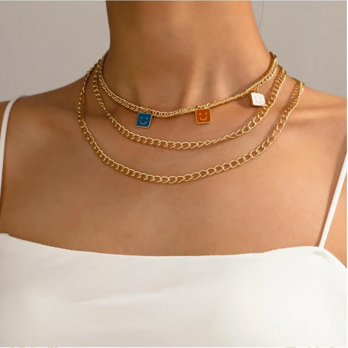Goldtone Layered Necklace With Blue, Orange White Happy Faces sold by Zulily