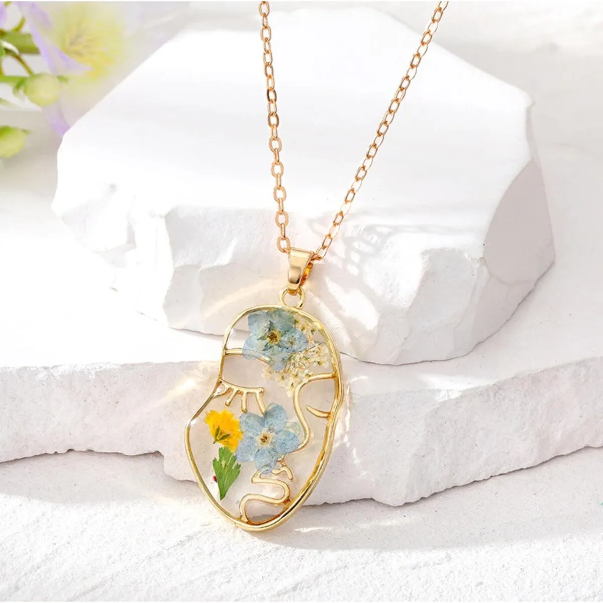 Goldtone Transparent Floral Abstract Face Pendant Necklace - White sold by Zulily