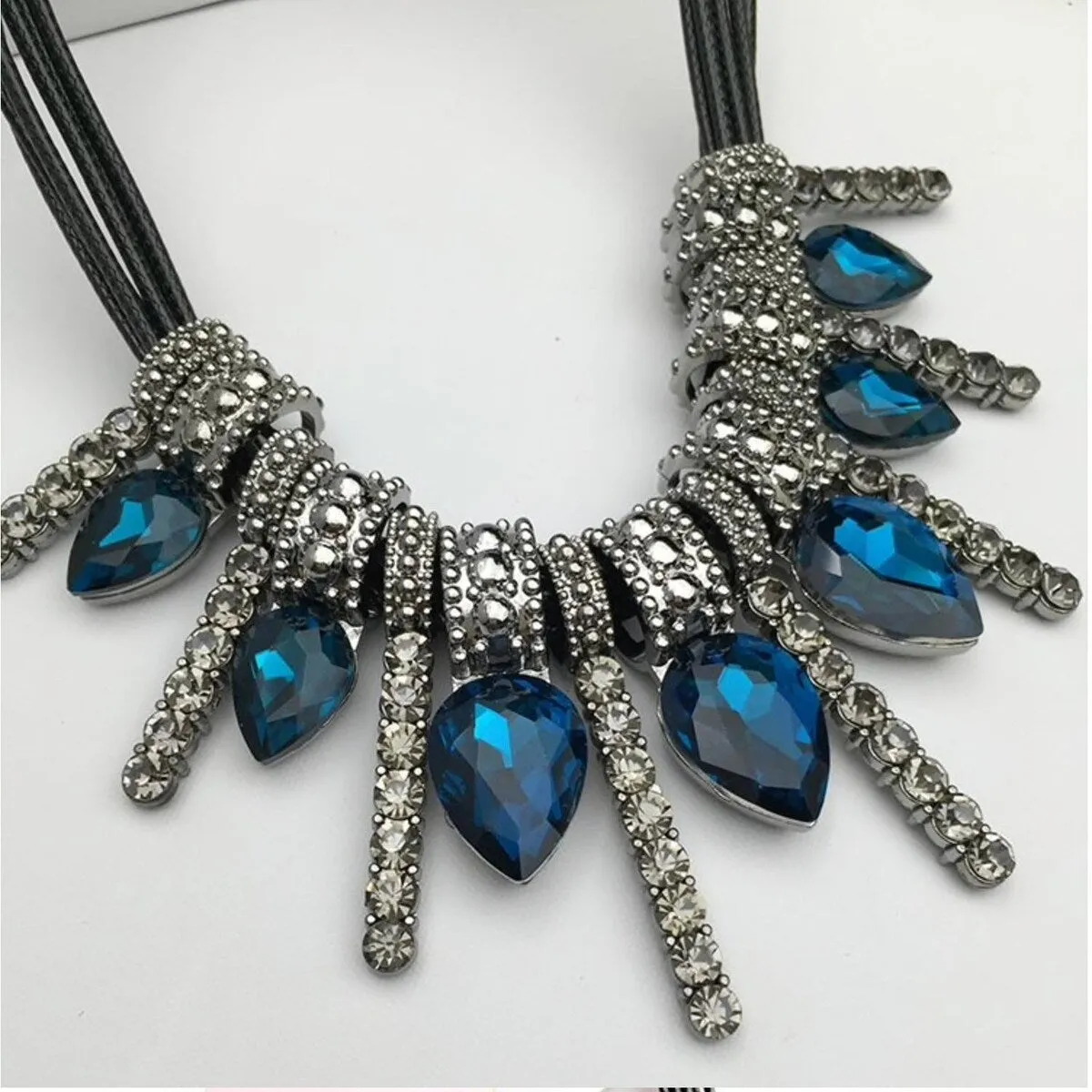 Black Blue Crystal Teardrop Statement Necklace - White sold by Zulily