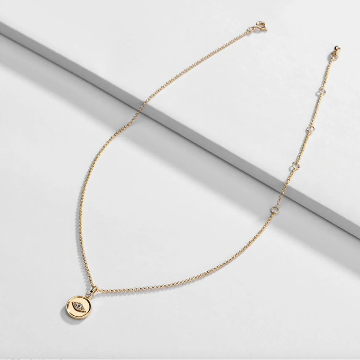 Goldtone Circular Necklace With Crystal Eye - White sold by Zulily