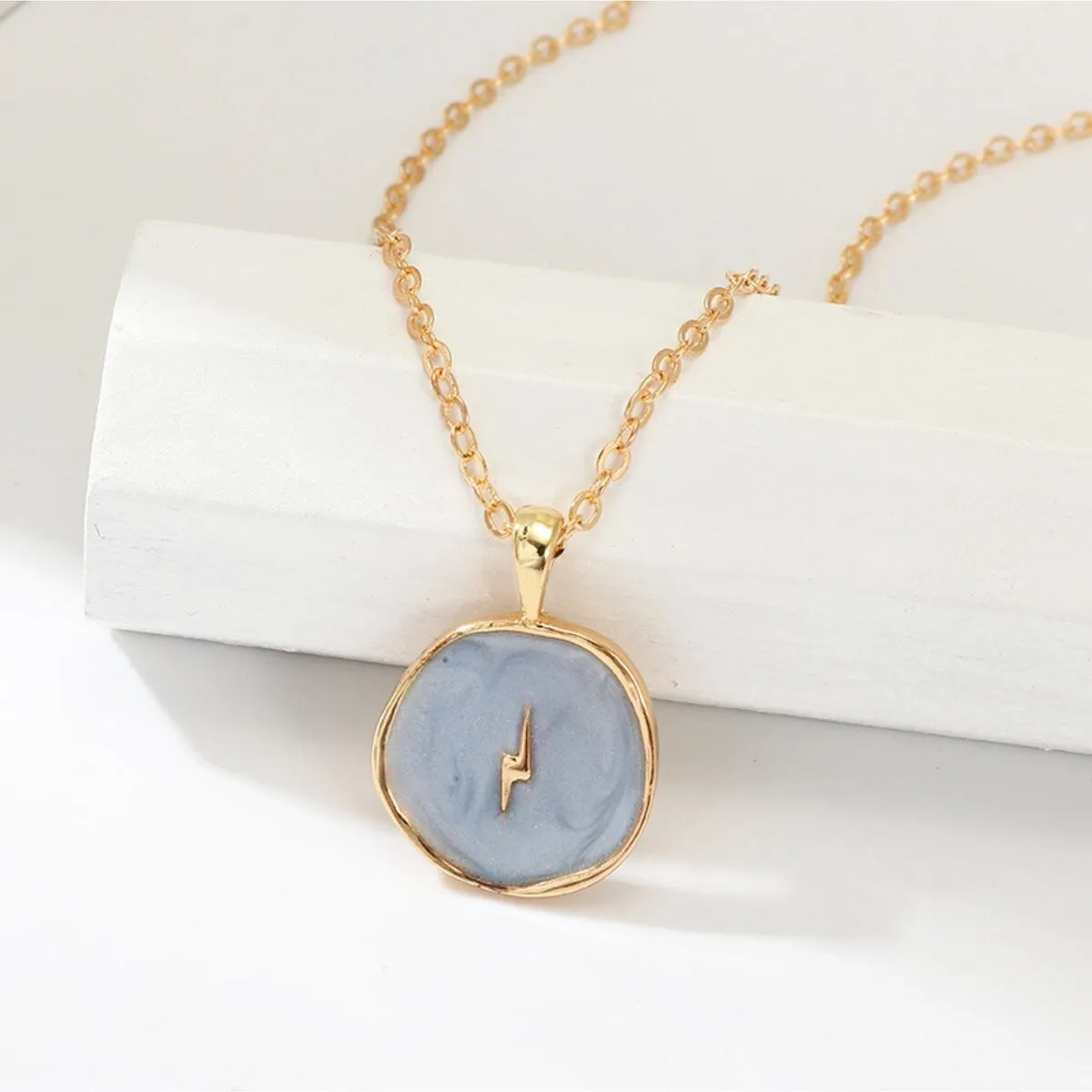 Goldtone Grey Circular Lightning Bolt Pendant Necklace - White sold by Zulily