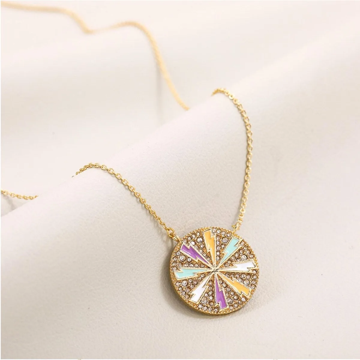 Goldtone Multi Colored Lightning Bolts Circular Pendant Necklace - White sold by Zulily