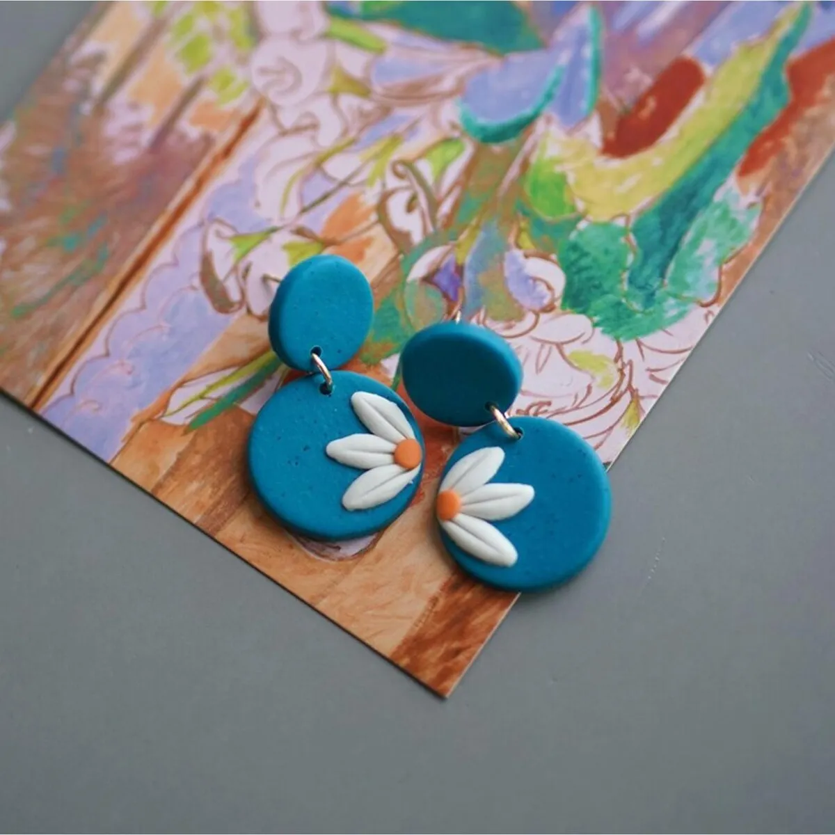 Goldtone Daisy Disc Clay Drop Earrings sold by Zulily