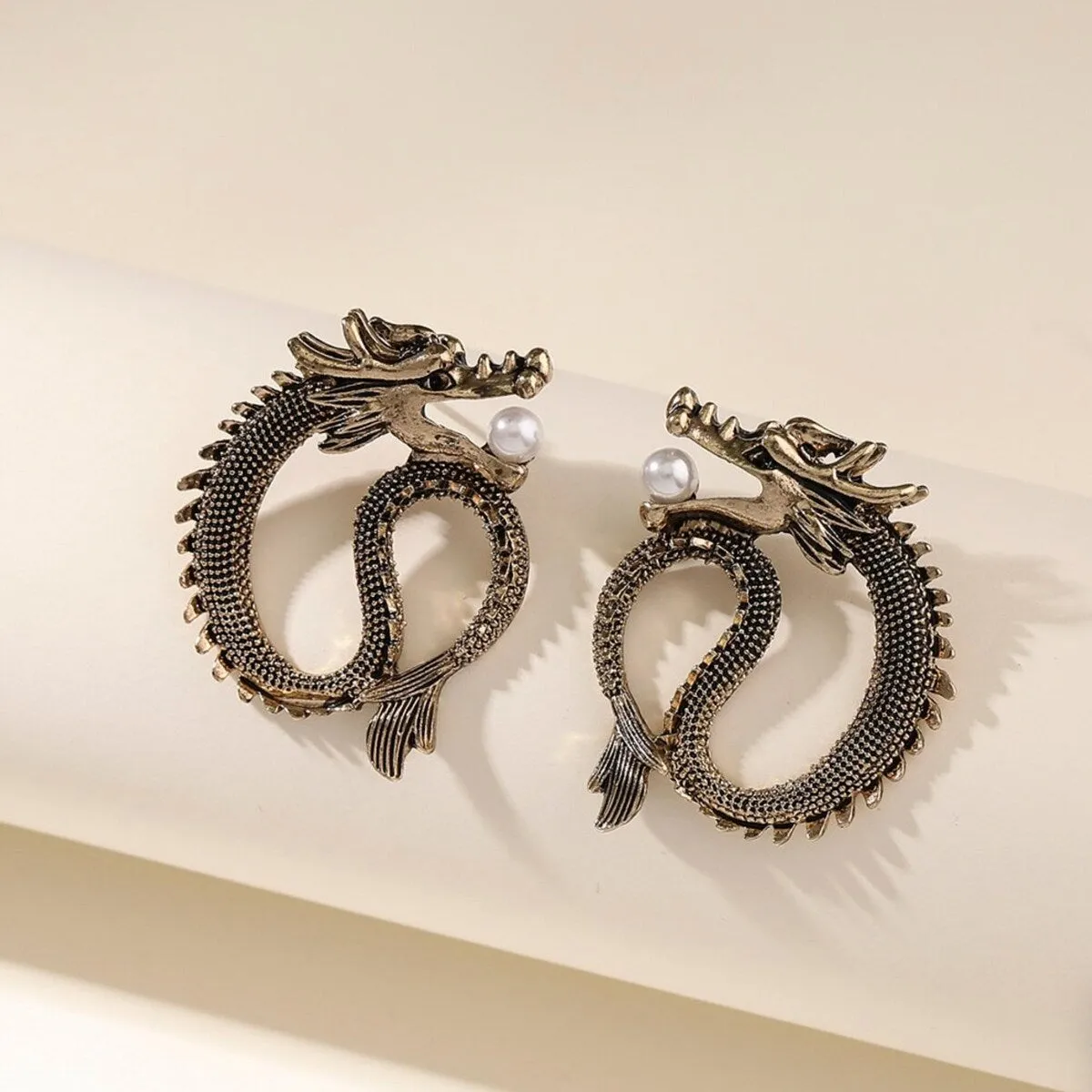 Brass Dragon With Imitation Pearl Stud Earrings sold by Zulily